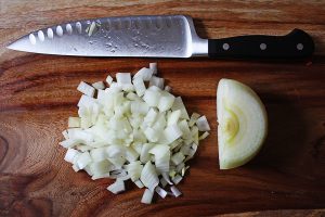 Onion prep for black bean vegetable soup with avocado