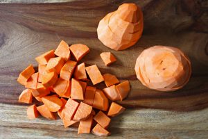 Chopping sweet potatoes for a sweet potato quinoa salad