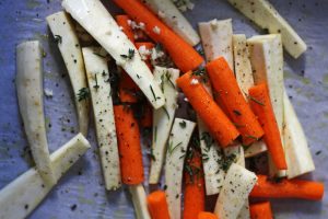 Toss your carrots and parsnips with rosemary, thyme, and garlic