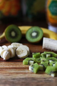 Chopped banana and kiwi to top your tropical green smoothie bowl
